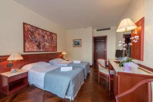 Letto o letti in una camera di Splendid Hotel La Torre