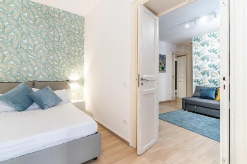 a bedroom with a bed and a couch in a room at Four Luxury Apartment in Palermo