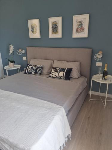 a bedroom with a large bed with blue walls at Sunset 221 Cagliari in Cagliari