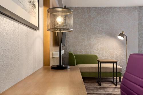 a living room with a lamp and a couch at Holiday Inn Philadelphia Arpt-Stadium Area by IHG in Philadelphia