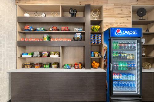 a soda machine in a grocery store with a drink cooler at Holiday Inn Philadelphia Arpt-Stadium Area by IHG in Philadelphia