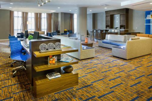 a lobby with couches and chairs in a building at Courtyard by Marriott Houston Galleria in Houston
