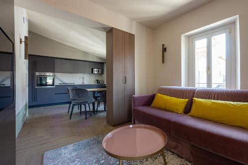 a living room with a couch and a table at Grand Universe La Residenza in Lucca
