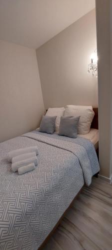 a bedroom with a bed with two pillows on it at DIVA contactless check in & out in Šiauliai