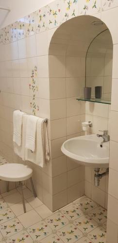a bathroom with a sink and a mirror and towels at Relais Zio Vincenzo Casa Positano in Positano