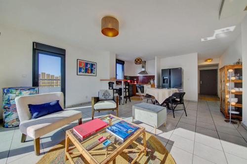 a living room with a couch and a table at La Terrasse - Apt T3 Saint Pierre in Saint-Pierre