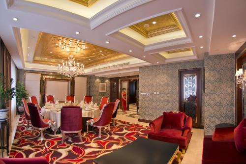 a conference room with a table and chairs and a chandelier at Overseas Chinese Hotel Wenzhou in Wenzhou