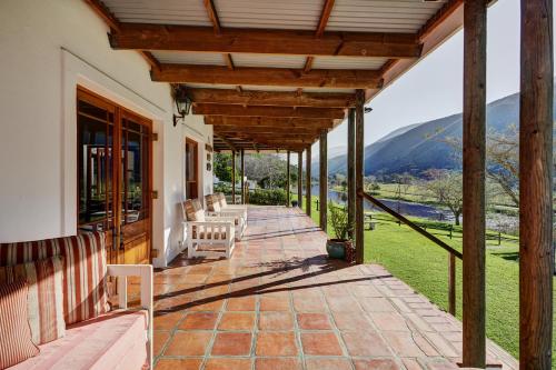 a porch with a view of a mountain at Somerset Gift Getaway Farm in Swellendam