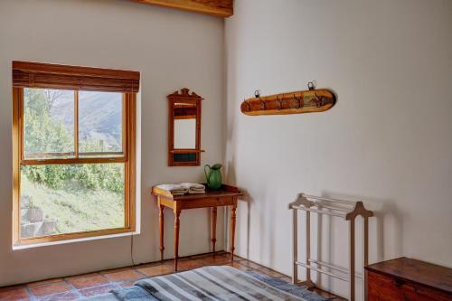 a room with a window and a table and a bed at Somerset Gift Getaway Farm in Swellendam