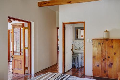 a hallway with two doors and a sink in a room at Somerset Gift Getaway Farm in Swellendam
