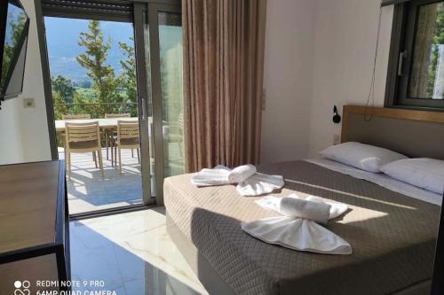 a hotel room with two beds and a balcony at Luxury Villa Serani with Panoramic View in Vasiliki