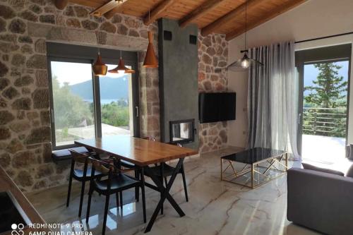 a dining room with a wooden table and chairs at Luxury Villa Serani with Panoramic View in Vasiliki