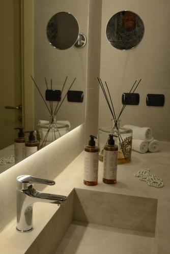 a bathroom counter with a sink and a mirror at Hotel Villa Cappugi in Pistoia
