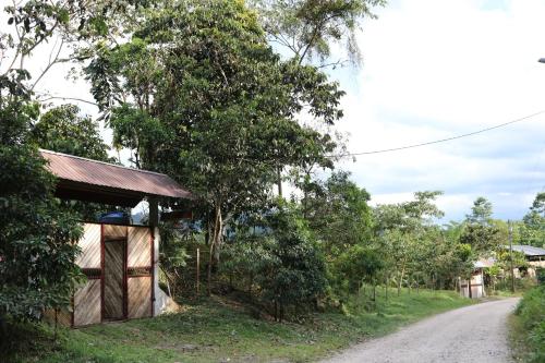 a small building on the side of a dirt road at Candurumy Lodge in Tena