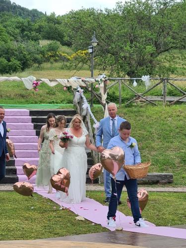 a bride and groom walking down the aisle at their wedding at Bed & Breakfast Villa Monterosso in Sassoferrato