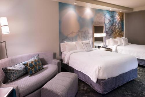 pokój hotelowy z 2 łóżkami i kanapą w obiekcie Courtyard by Marriott Hot Springs w mieście Hot Springs