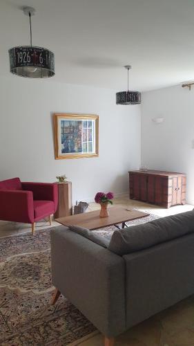 a living room with a couch and a table at L'Embellie in Quintin