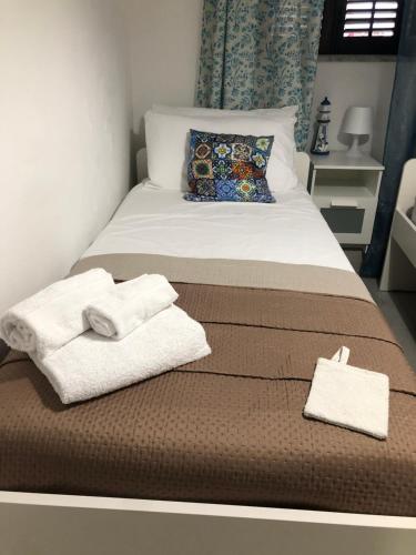 a bedroom with a bed with towels on it at Tampasiando in Cinisi