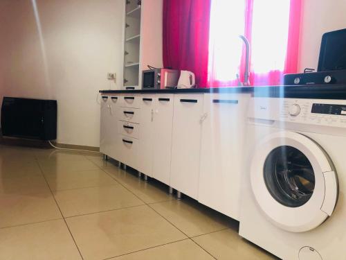 a laundry room with a washer and a washing machine at Old Rabati in Akhaltsikhe