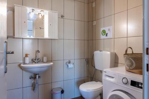 a small bathroom with a toilet and a sink at Studio on the closest beach to the city! in Amoudara Herakliou