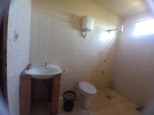 uma casa de banho com um lavatório e um WC em Hostal los lobos. em Ciudad del Este