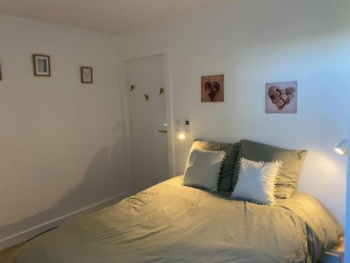 a bedroom with a bed with two pillows on it at Appartement Gérardmer in Gérardmer
