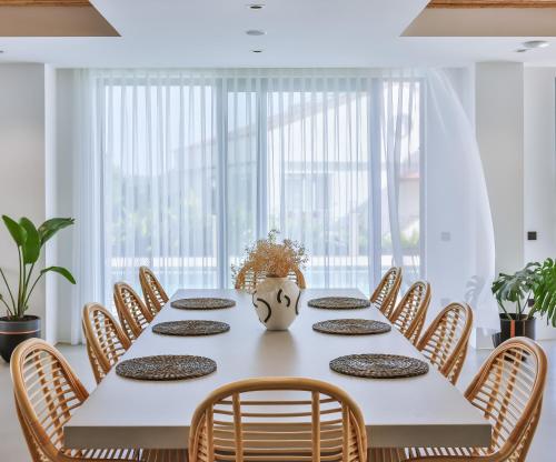 a dining room with a white table and chairs at Carruba Boutique Hotel in Kas