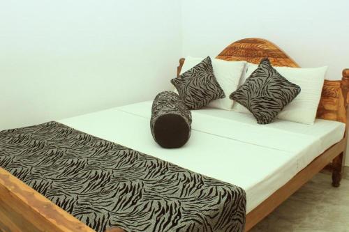 Postel nebo postele na pokoji v ubytování Keerthi Homestay