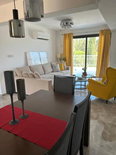 a living room with a table and a couch at Luxury Kouklia Apartments in Kouklia