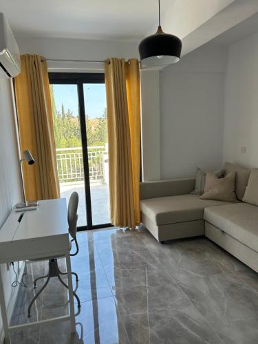 a living room with a couch and a table at Luxury Kouklia Apartments in Kouklia