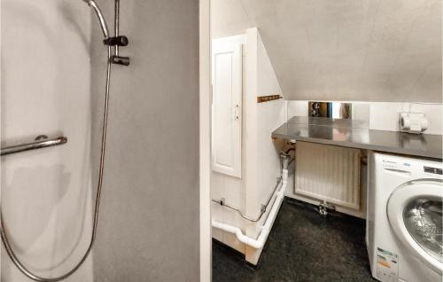 a bathroom with a sink and a washing machine at Gorgeous Apartment In Halmstad With House Sea View in Halmstad