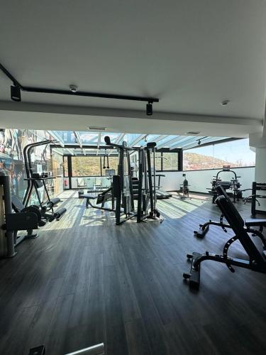 a gym with a bunch of treadmills and machines at Well Hotel & Spa in Maceira