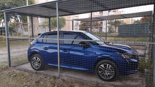 a blue car parked inside of a cage at Las Colinas in Salta