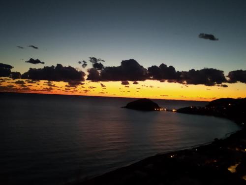 a sunset over a body of water at Hotel Villa al Mare in Ischia