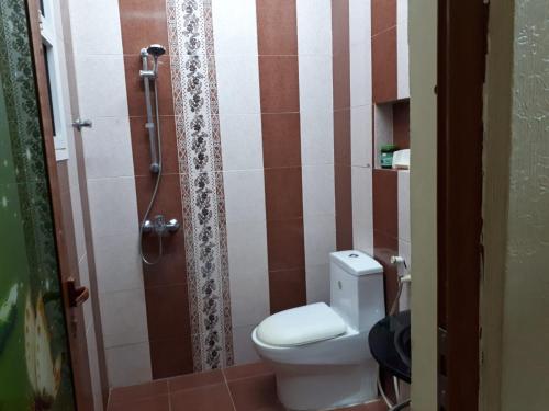 a bathroom with a toilet and a shower at The calm place in Nizwa in Al Jināh