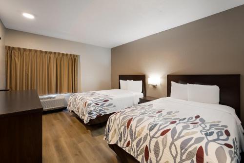 a hotel room with two beds and a window at Red Roof Inn Tucson North - Marana in Tucson