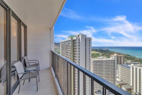 a balcony with chairs and a view of the ocean at Standard Ocean View Condo - 36th Floor, Free parking & Wifi condo in Honolulu