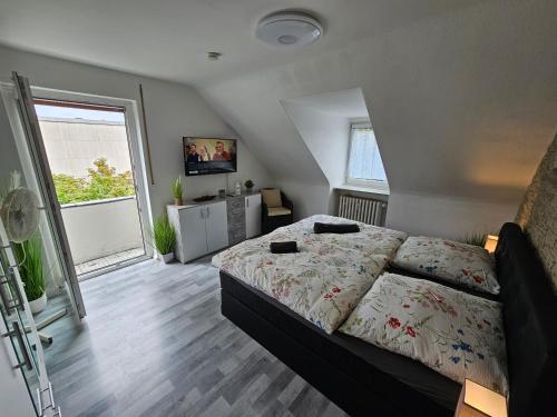 - une chambre avec un lit et une grande fenêtre dans l'établissement Exklusives und helles Dachgeschoss-Apartment No 3 im Zentrum von Kassel, schnelles 1Gbit Internet, Geschirrspüler, Boxspringbetten, à Cassel