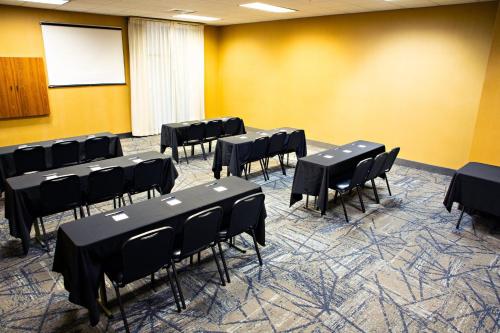 a conference room with black tables and chairs at Holiday Inn Express & Suites Harrisburg West in Mechanicsburg