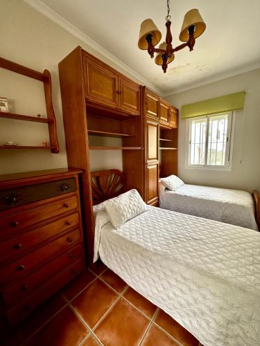 - une chambre avec 2 lits et une commode dans l'établissement Villa Grazalema casa rural con encanto, à Grazalema