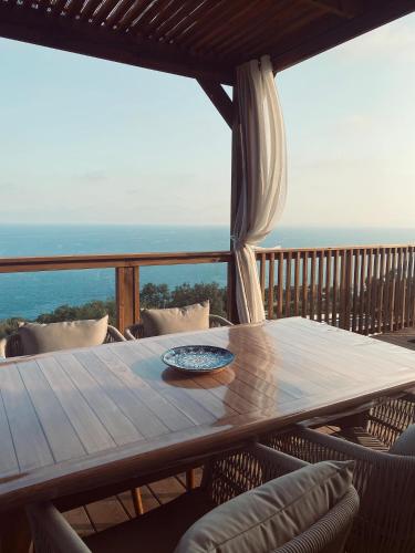 a table on a balcony with a view of the ocean at Mobile Evasion okpl BEAUVOIR in Saint-Raphaël