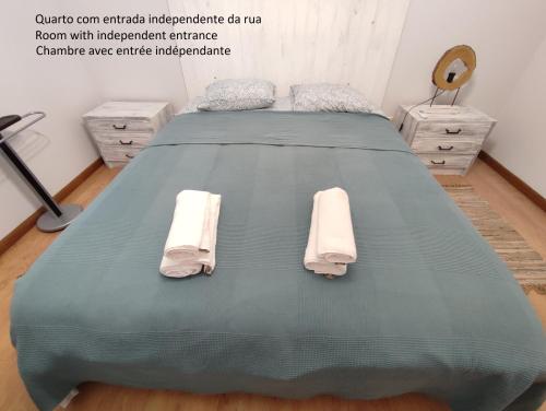 a bed with two towels on it in a room at Segredos da Montanha - Seia in Seia