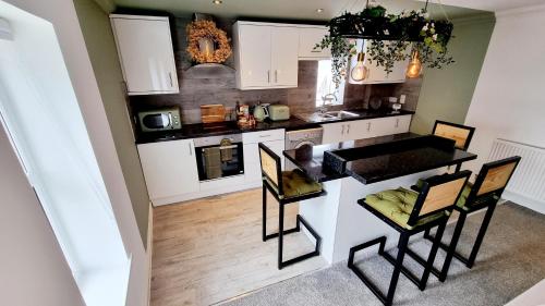 an aerial view of a kitchen with a table and chairs at Bed& Boujee by the pier in Paignton