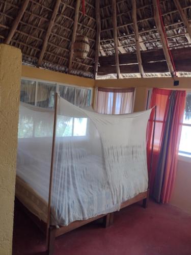 a bedroom with a bed in a room at Posada Ecohabitas in Mazunte