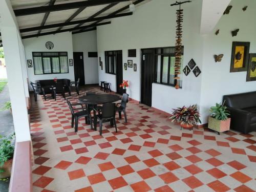a living room with a checkered floor at Finca Hotel El SAMAN de alto bonito in Montenegro