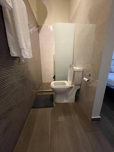a bathroom with a toilet and a shower at City apartment in Korinthos