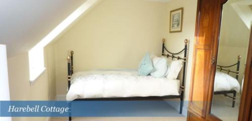 a bedroom with a bed in a stair room at Harebell Cottage in Killean