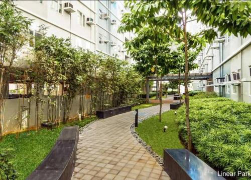 a courtyard with benches and trees in a building at Condo in Quezon City, Trees Residences Tower 16 in Manila