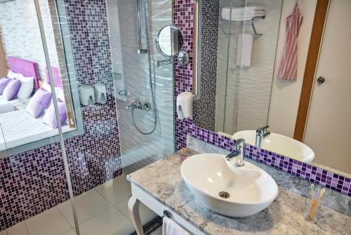 a bathroom with a sink and a shower at Tui Magic Life Jacaranda in Side