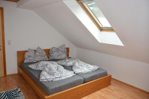 a bed with pillows on it in a attic at Happy Point Apartment in Mellau